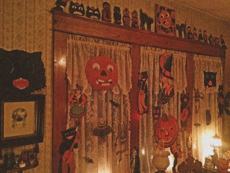 halloween decorations are hanging on the wall in a room with pumpkins and other items