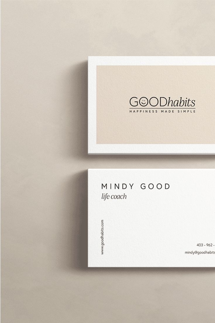 two white business cards with the words good habitts on them, sitting next to each other