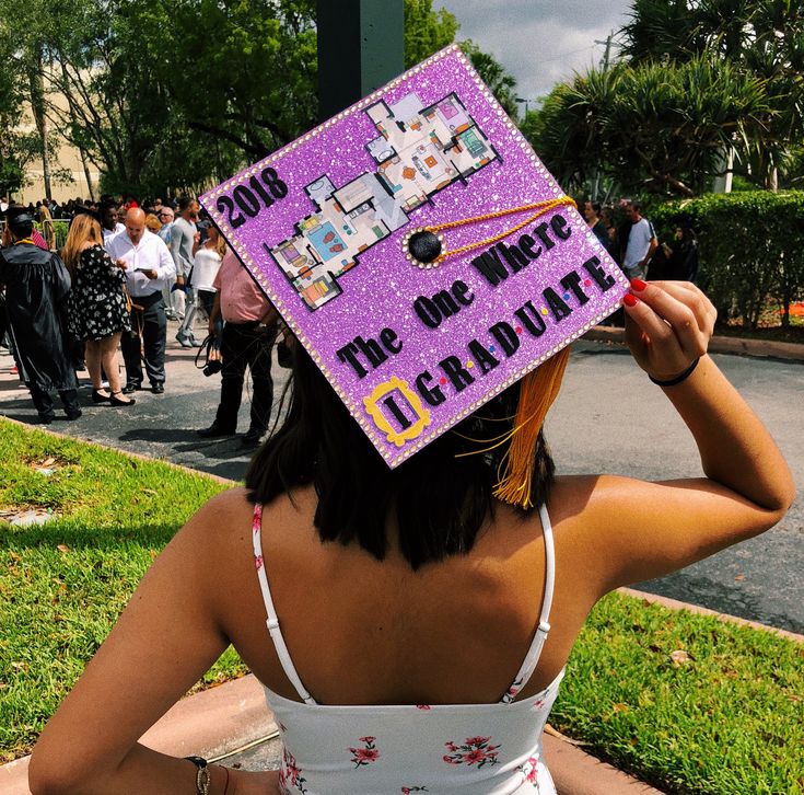 a woman wearing a purple graduation cap with pictures on it