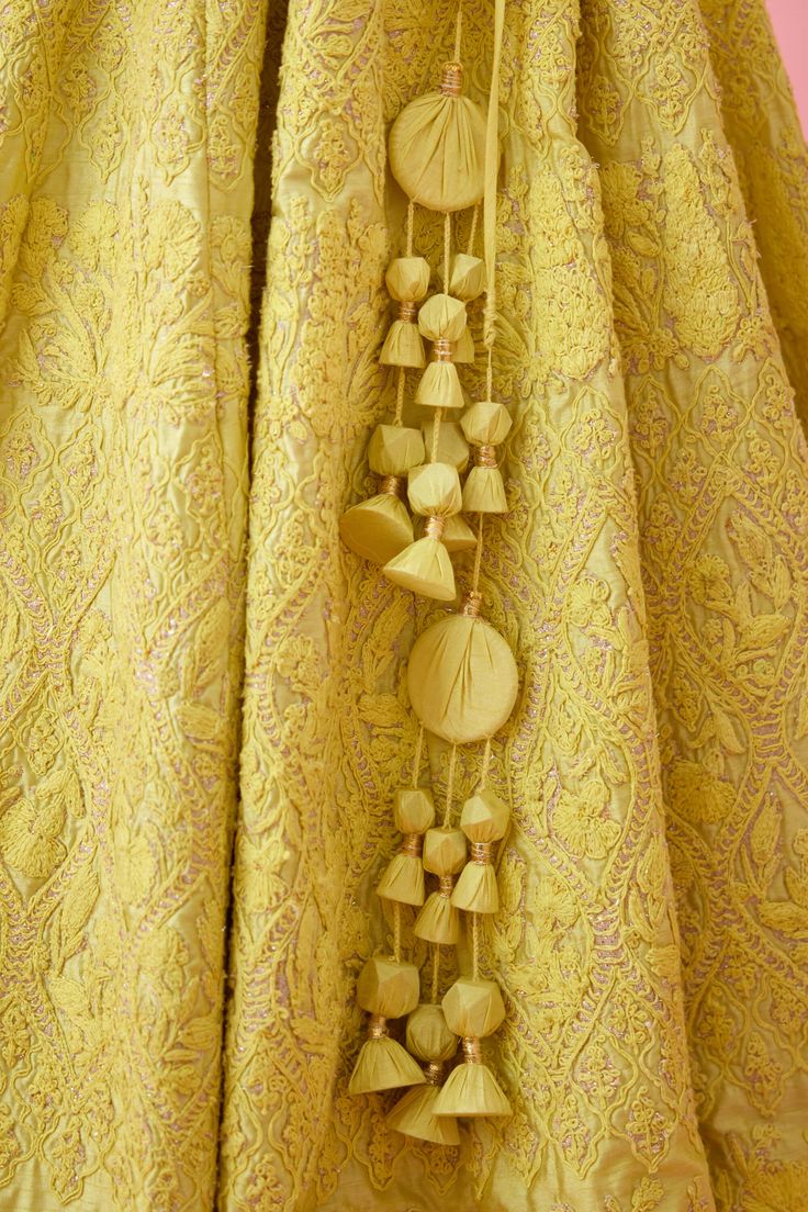 Editor's Note This beautiful lehenga set features intricate patchwork and thread embroidery on a flowing skirt, paired with a matching dupatta. The ensemble is perfect for weddings, formal events, or any special occasion where you want to make a statement. The high-quality craftsmanship and attention to detail make this lehenga set a stunning addition to any wardrobe. Color: Yellow Fabric: Raw silk Embroidery details: Patchwork & thread embroidery Components: Lehenga, dupatta & blouse Occasion: Luxury Art Silk Dupatta With Tilla Details, Luxury Raw Silk Cutdana Dupatta, Luxury Silk Thread Dupatta With Intricate Embroidery, Luxury Lehenga With Silk Thread And Pallu Detail, Luxury Cotton Silk Choli For Designer Wear, Luxury Traditional Wear With Handwork In Chinon, Luxury Silk Thread Dupatta With Handwork, Luxury Handwork Silk Thread Dupatta, Luxury Silk Thread Lehenga With Handwork