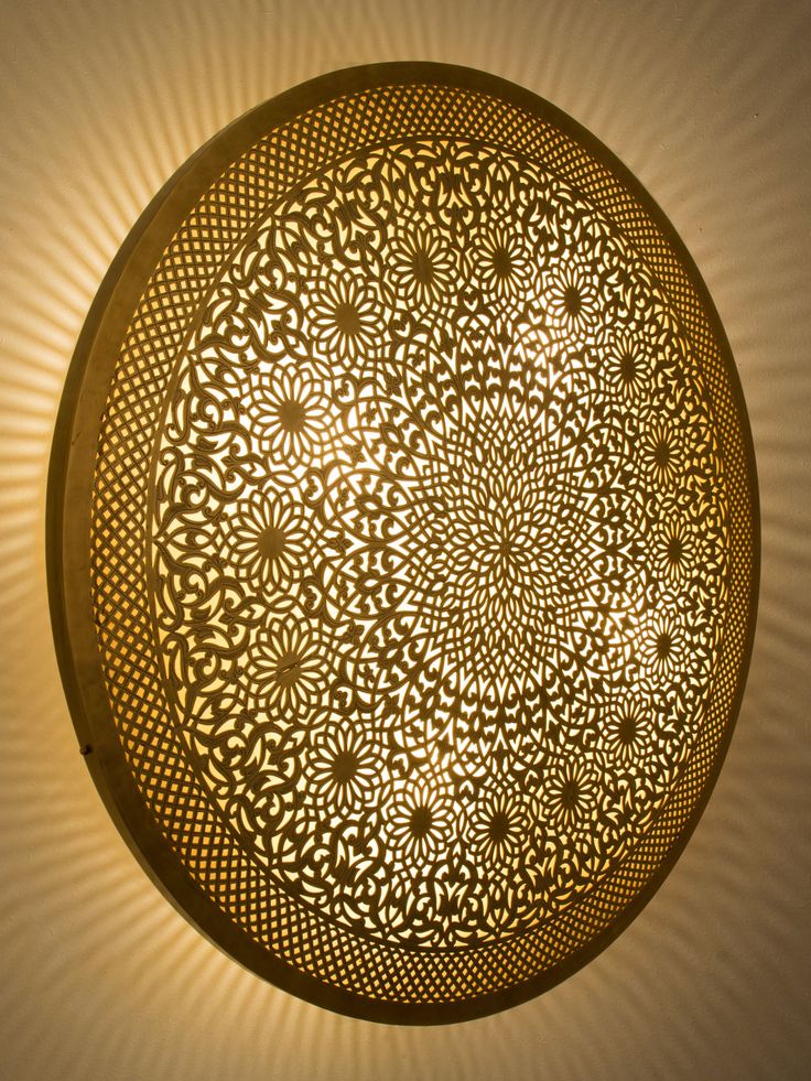 an intricately designed light fixture is shown in the shape of a circular flower pattern