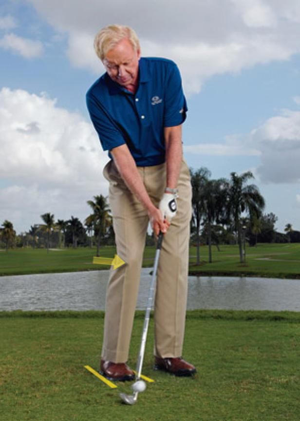 an older man is playing golf on the grass