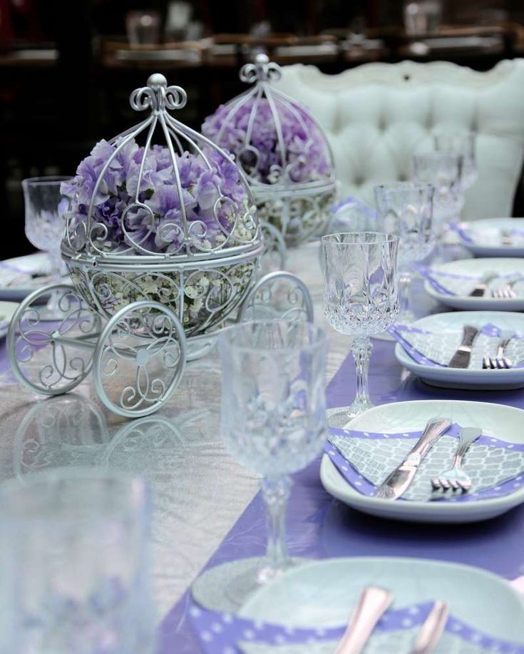 the table is set with purple and white dishes