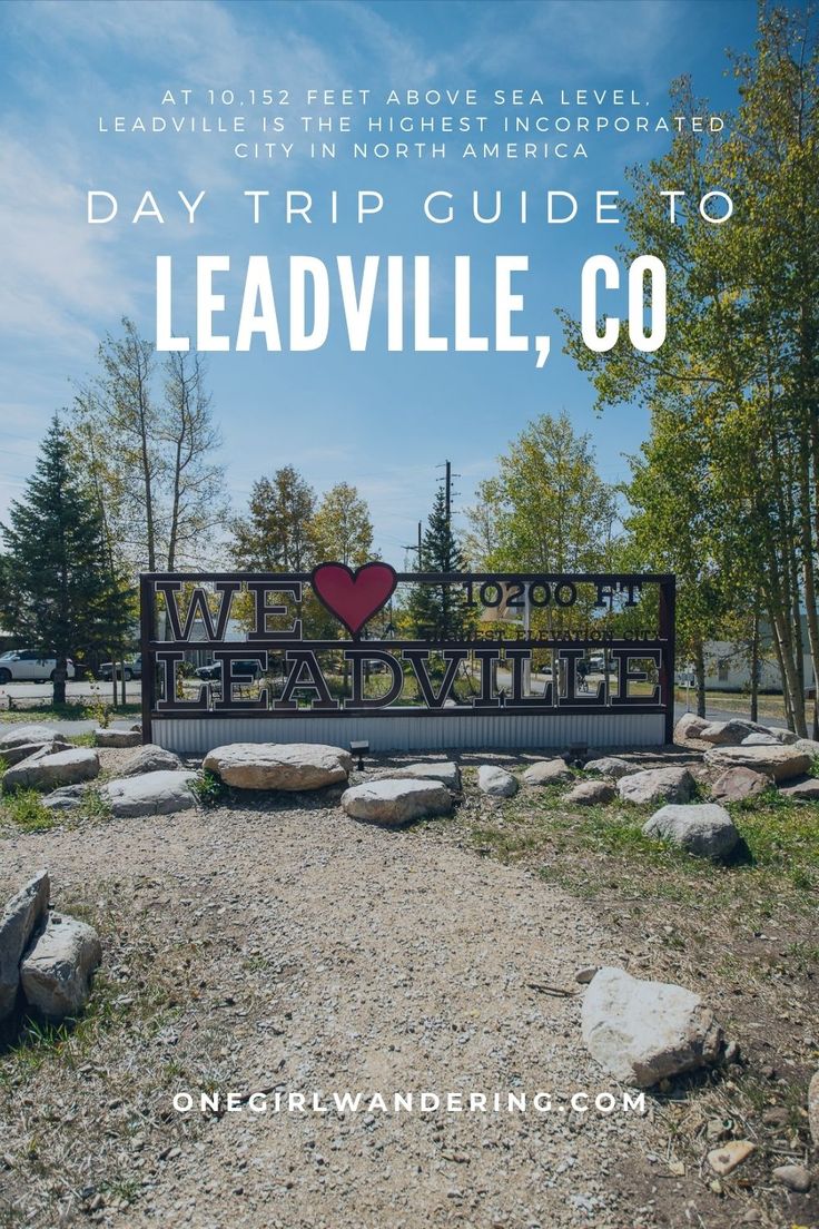 a sign with the words, we love to leadville co in front of rocks and trees