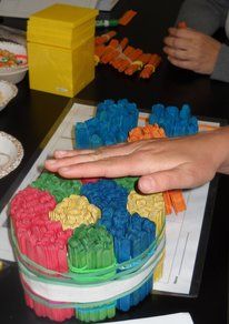 a person reaching out their hand to grab something from a plastic container on a table