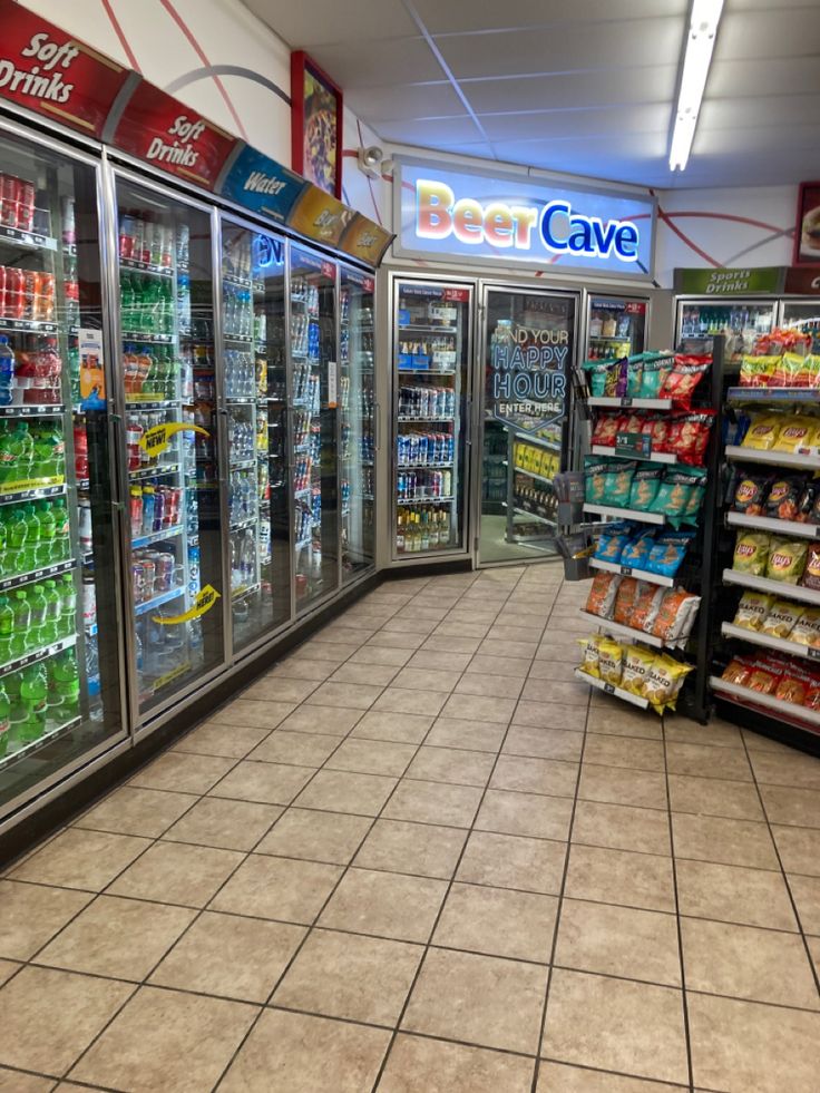 an empty grocery store filled with lots of food and drink coolers next to each other