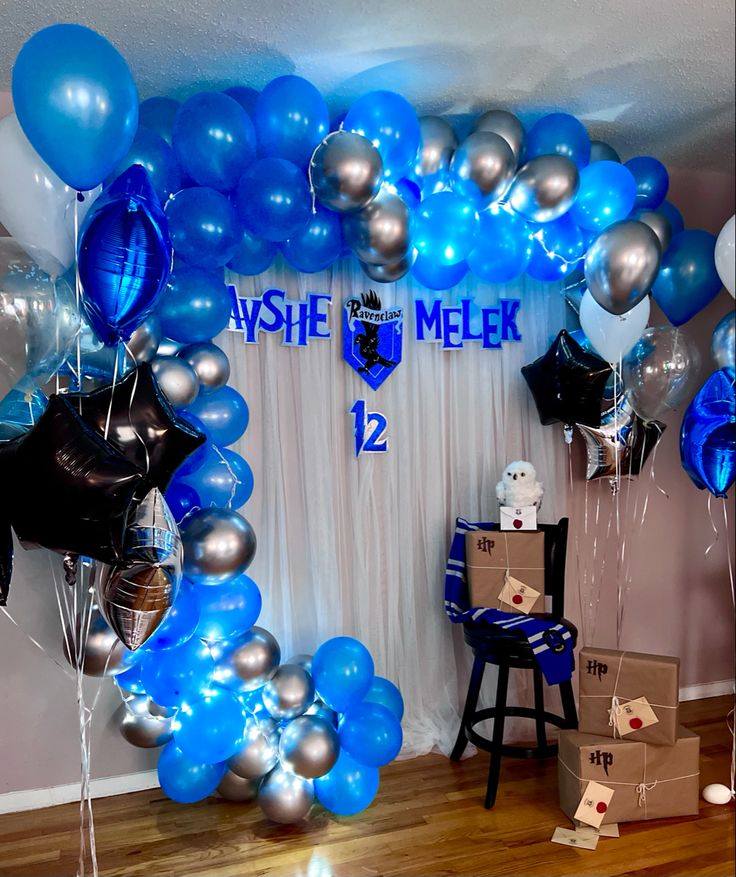 blue and silver balloons are on display in the room