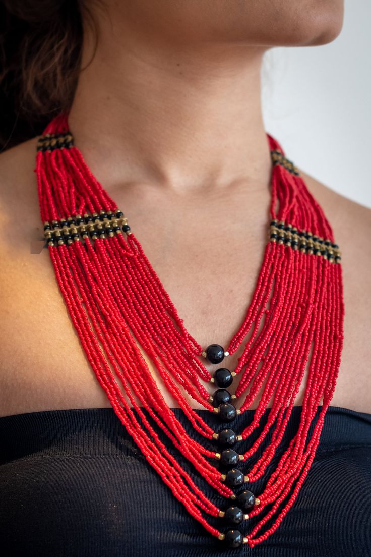 "Beautifull red layered necklace that is a true eye catcher. These nepalese traditional craftmanship necklaces (Mala) are made with a modern touch. A \"pote\" is a traditional nepali necklace made by stringing small cut (glass) beads. This necklace is designed in a trending long style and is durable and skin friendly." Fair Trade Red Jewelry For Festivals, Red Fair Trade Jewelry For Festivals, Fair Trade Jewelry For Festivals, Festive Fair Trade Jewelry For Festivals, Red Fair Trade Jewelry With Round Beads, Red Fair Trade Necklace As Gift, Traditional Multi-strand Beaded Necklaces For Festivals, Traditional Multi-strand Beaded Necklaces For Festive Occasions, Red Bohemian Necklace For Puja