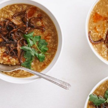 three bowls filled with soup and garnished with parsley