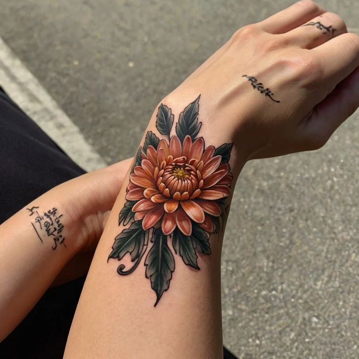 a woman's arm with a flower tattoo on it