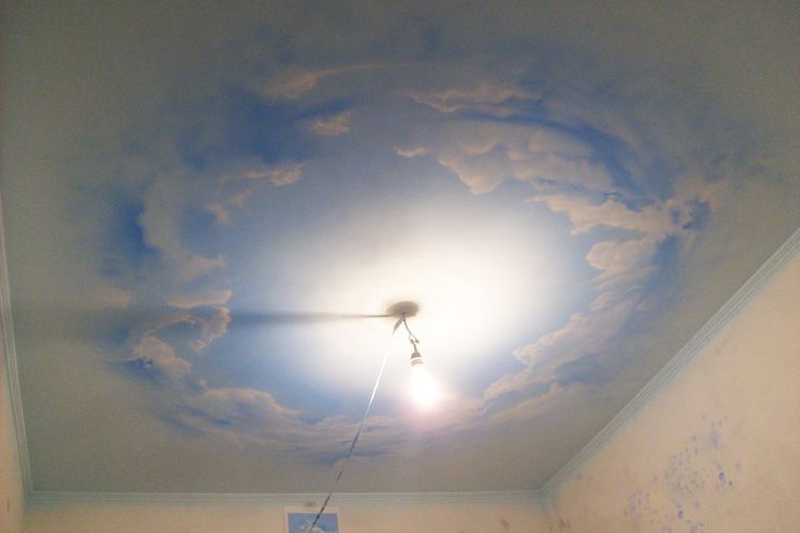 a room with a ceiling painted like a cloud and a light fixture in the middle