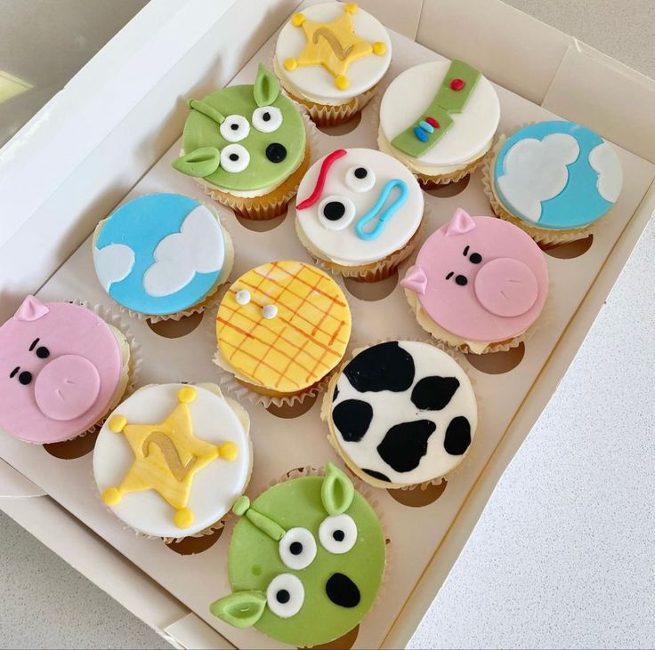 a box filled with cupcakes decorated to look like farm animals