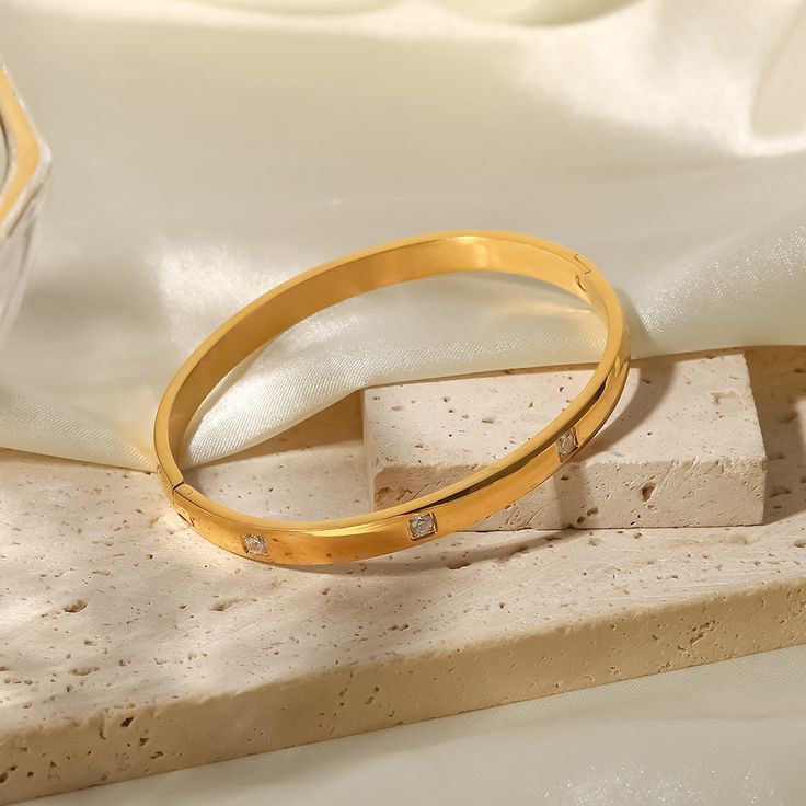 Elevate your style with the Crystal Bangle Bracelet. This stunning piece features brilliant crystals on an 18k gold-plated bangle, offering both glamour and sophistication. The Bangles, Gemstone Bangle, Stainless Steel Bangles, Crystal Bangle, Stone Bangle, Simple Bracelets, Elegant Bracelet, Minimalist Bracelet, Gold Plated Bracelets