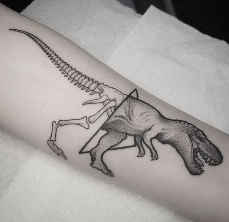 a black and white photo of a dinosaur with a skeleton on it's arm