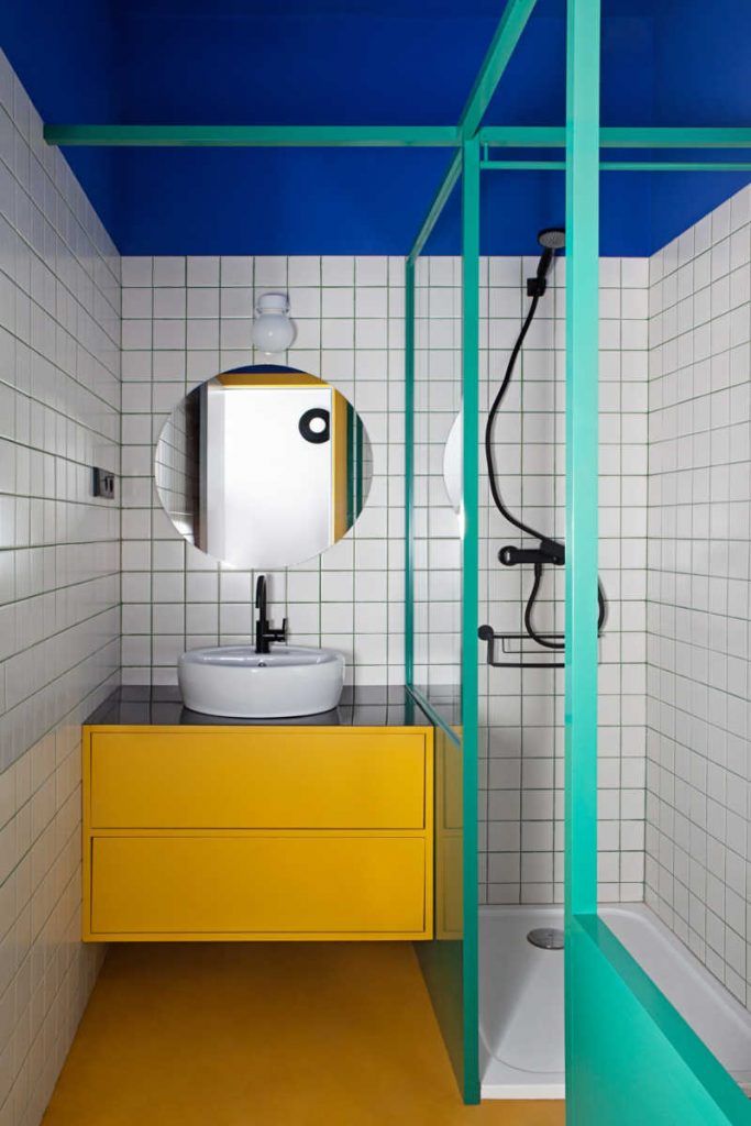 a bathroom with blue, yellow and white walls