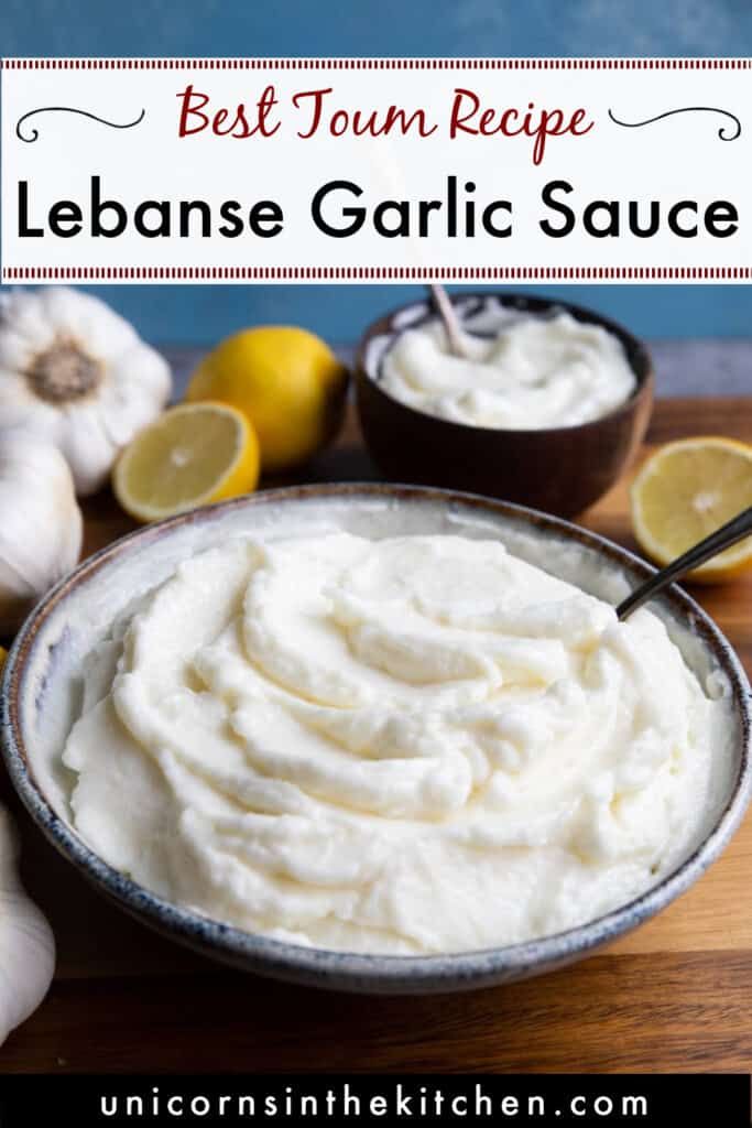 a bowl filled with lemon garlic sauce on top of a wooden cutting board