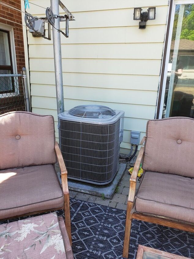 two chairs and an air conditioner on a patio