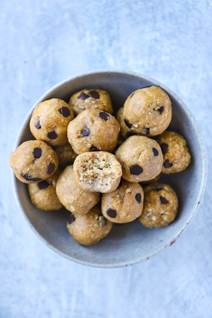 a bowl filled with chocolate chip cookies on top of a table