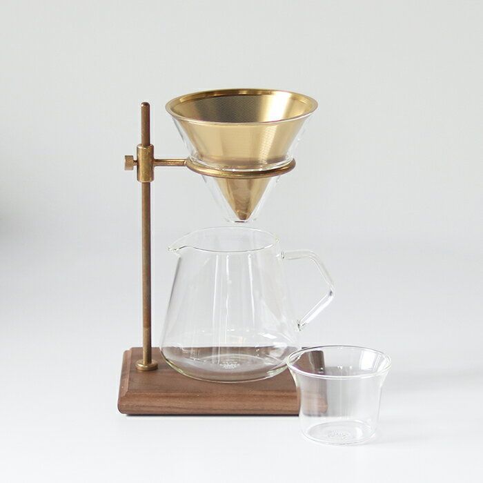 a coffee maker with a glass cup and wooden stand