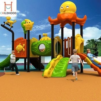 children are playing in the playground at the beach