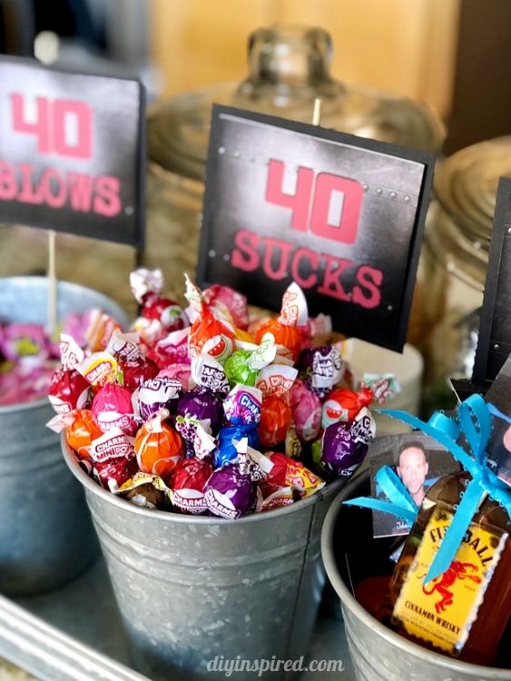 two buckets filled with candy sitting on top of a metal tray next to each other