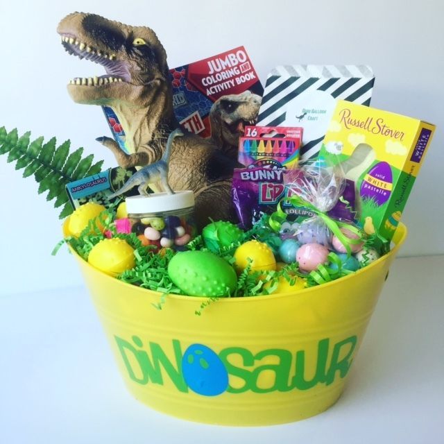 a yellow bucket filled with lots of toys and other items on top of a table