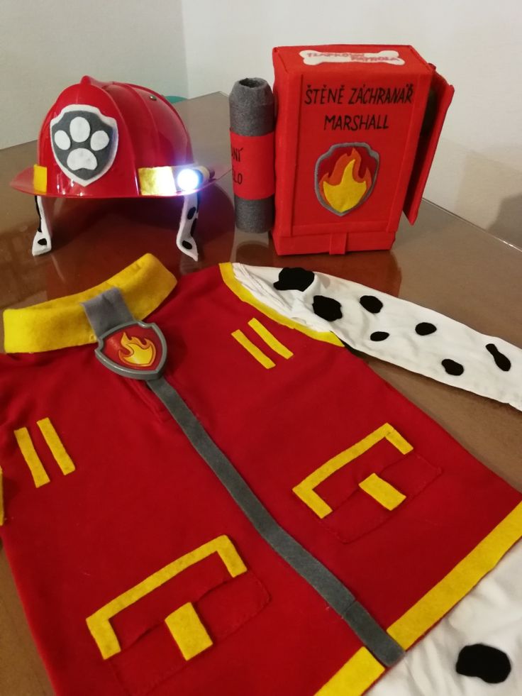 a fireman's uniform and helmet on a table