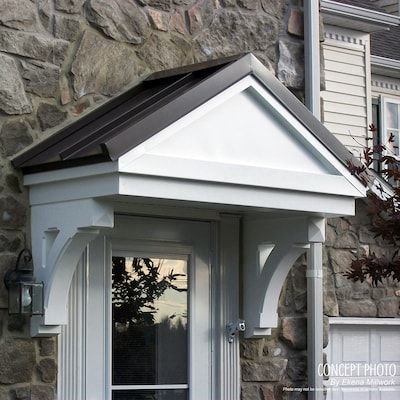 a white door and window in front of a stone building