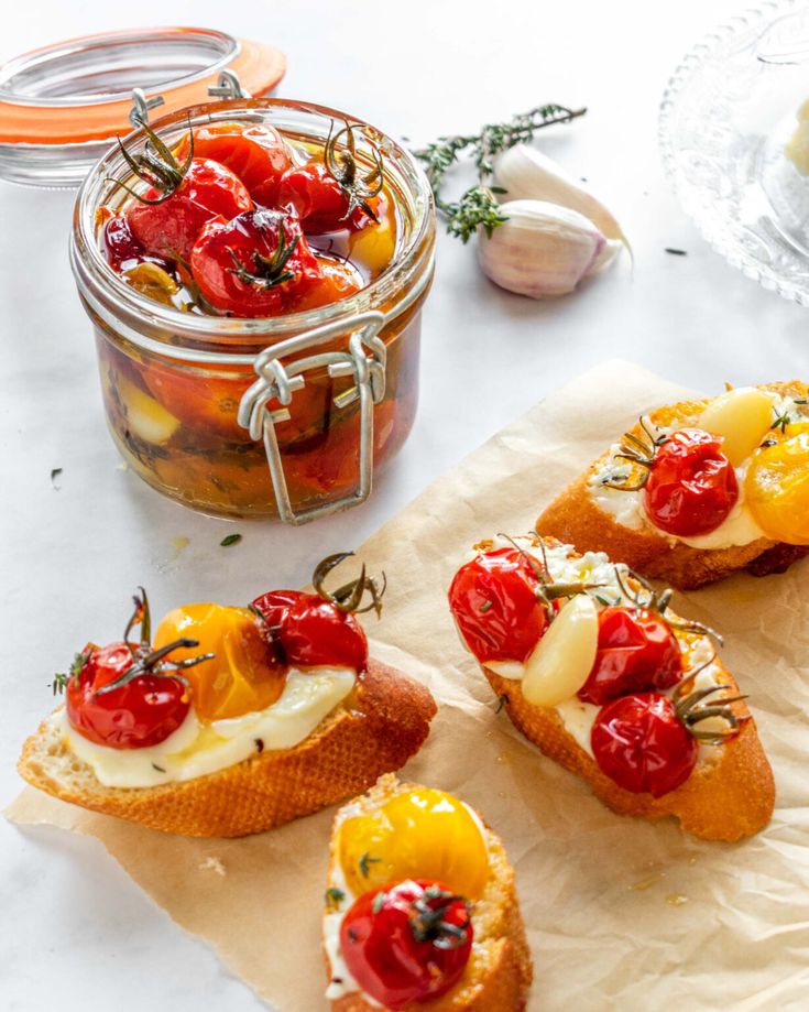 small crostini with tomatoes, cheese and herbs in a jar on a table