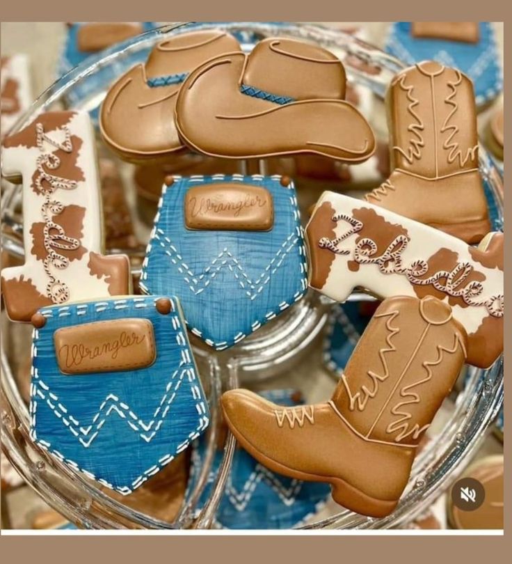 some cookies that are in the shape of cowboy boots and boots on top of each other