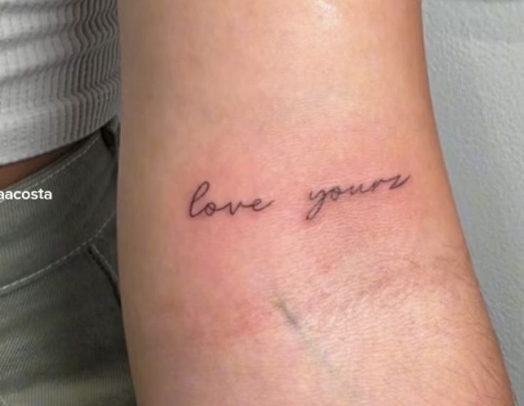 a woman's arm with the words love you written on it