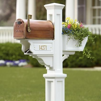 a white mailbox with flowers in it