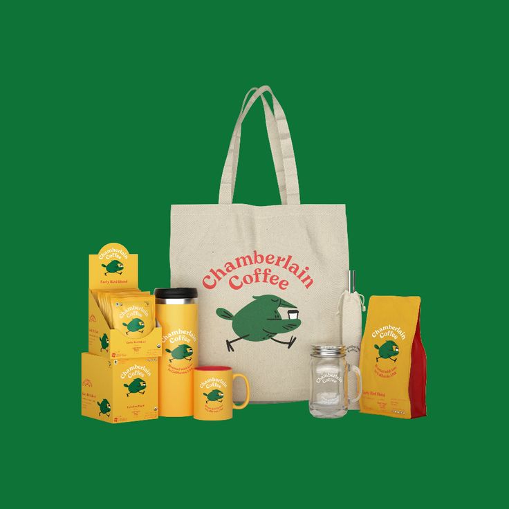 a tote bag with coffee and other items in front of it on a green background