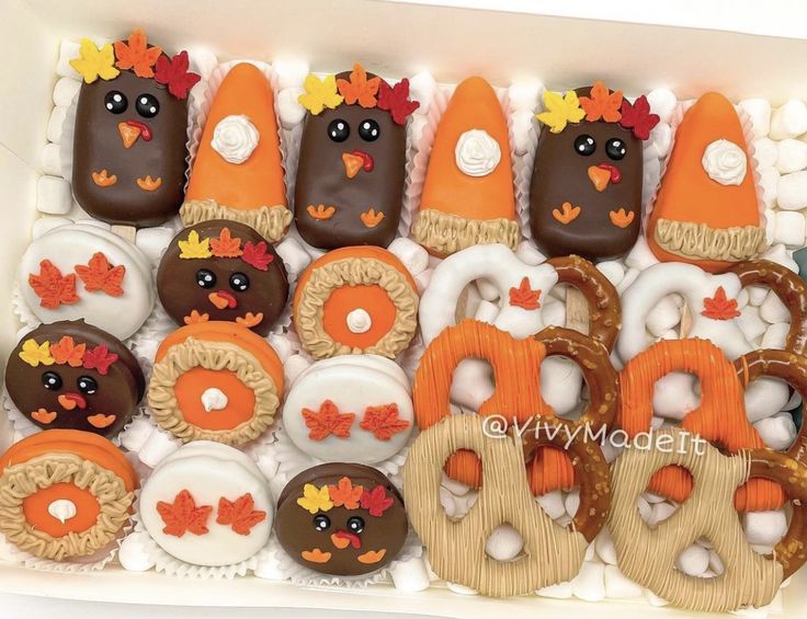 a box filled with lots of decorated cookies and pretzels in the shape of turkeys