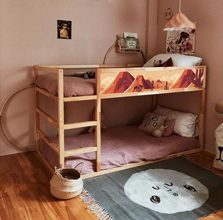 there is a bunk bed in this room with pink walls and wood floors, along with a rug on the floor