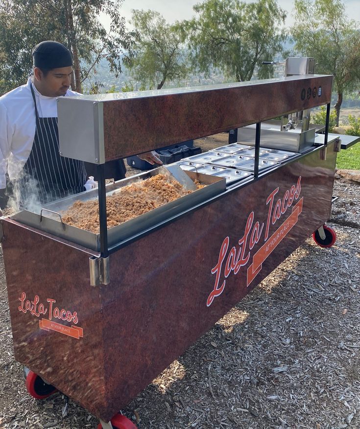 a man cooking food on top of a grill