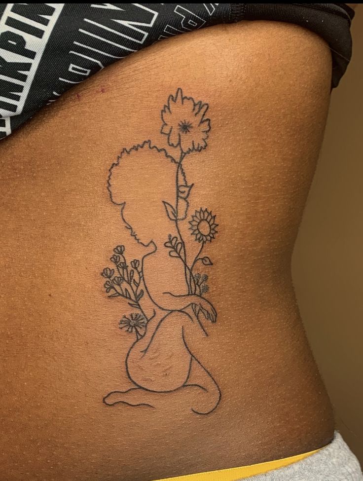 a woman with a flower tattoo on her stomach