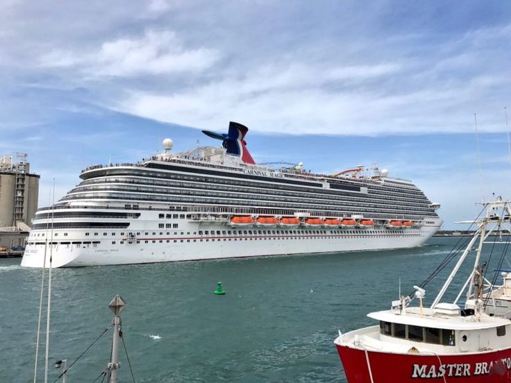 a large cruise ship in the water next to a dock