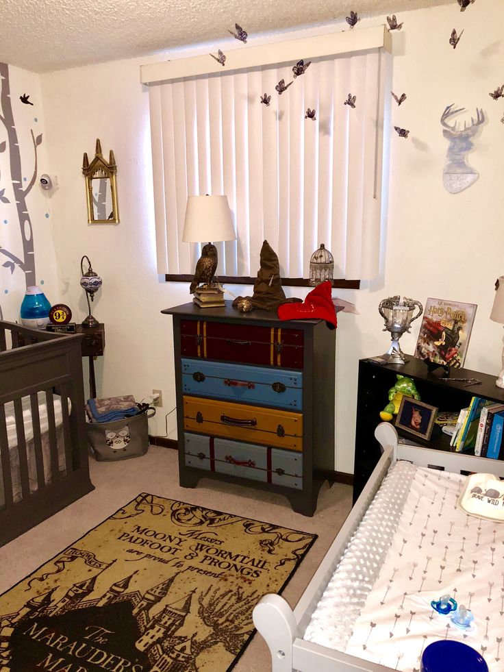 a baby's room with two cribs and a dresser