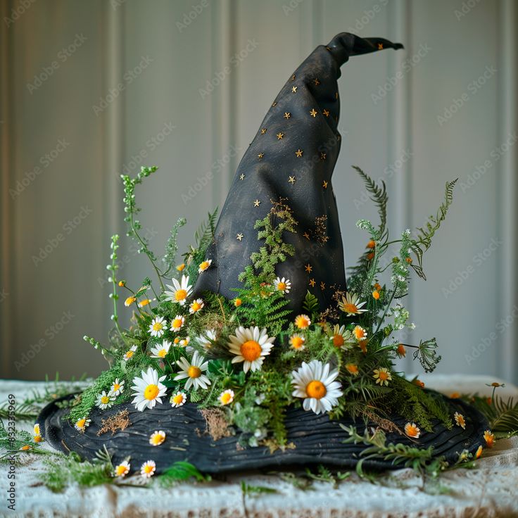 a witches hat with daisies and greenery