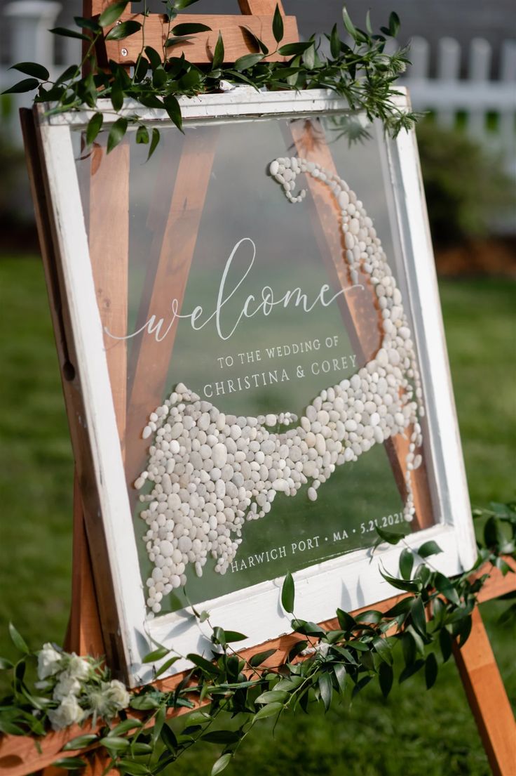 the welcome sign is decorated with flowers and greenery for an outdoor wedding in charlotte, north carolina