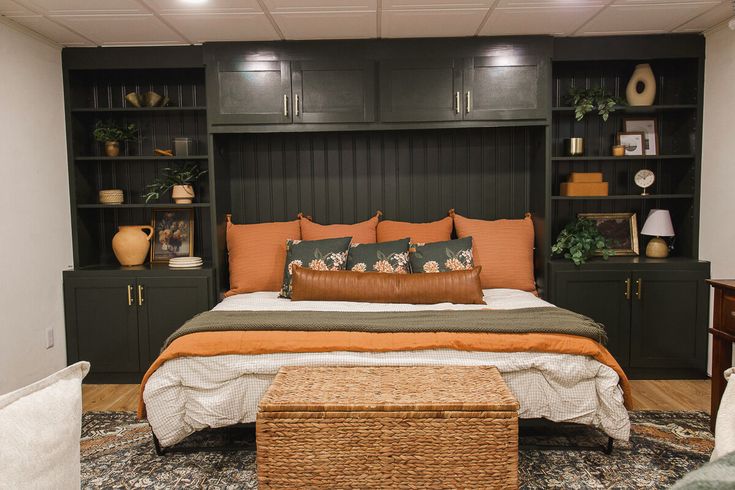 a large bed sitting in a bedroom next to a wooden dresser and bookcases