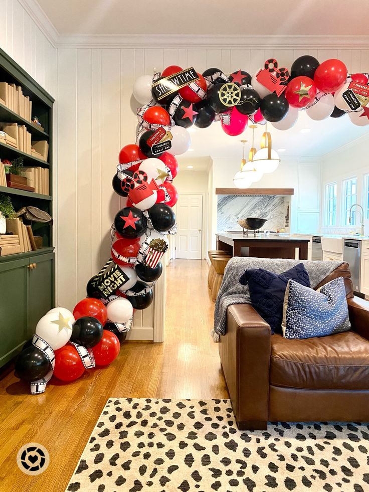 a living room filled with furniture and lots of balloons