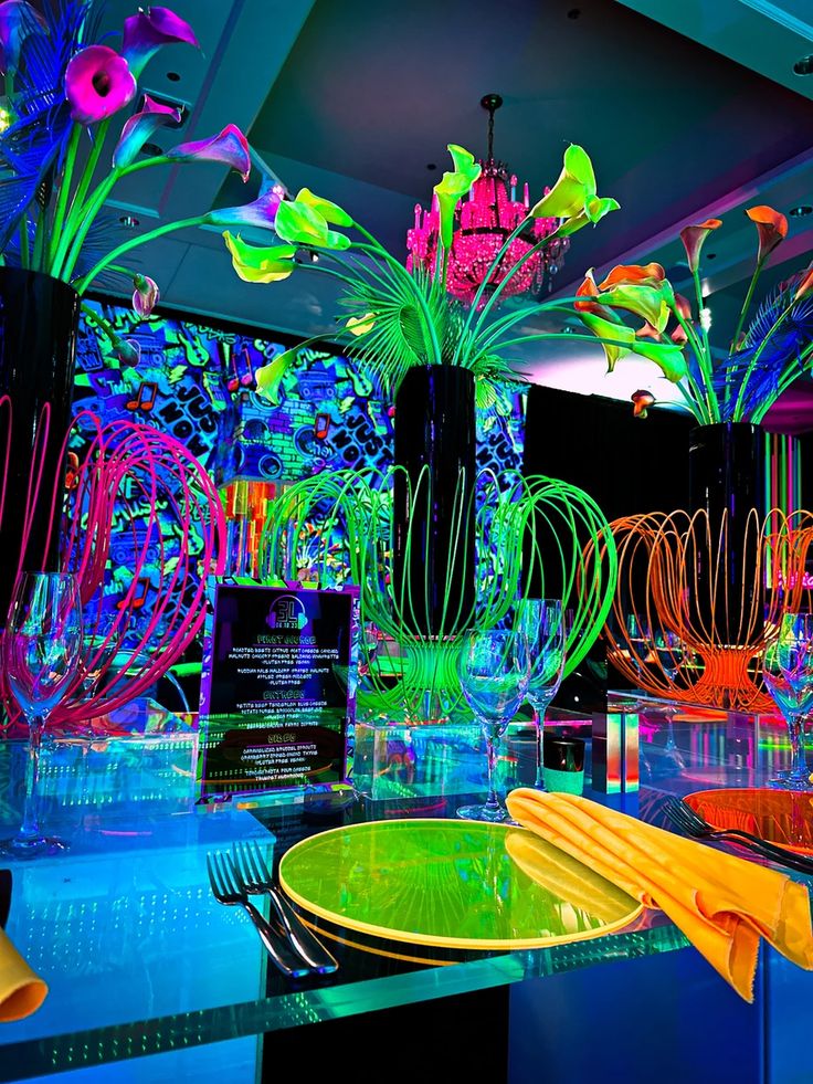 colorful glass vases filled with flowers and plants on display in a brightly lit room