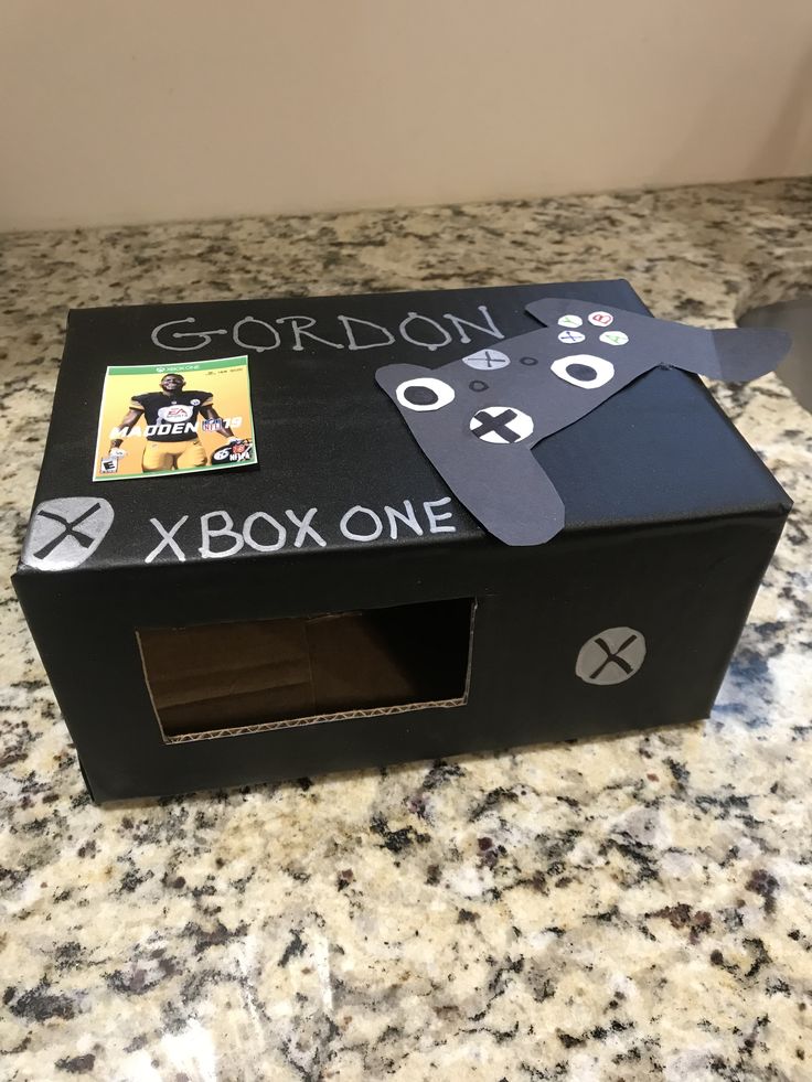 a cardboard box with an image of a man holding a video game controller in it