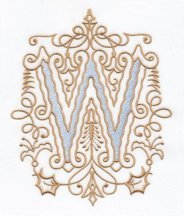 the letter w is made up of gold and blue embroidery on a white shirt with an intricate design