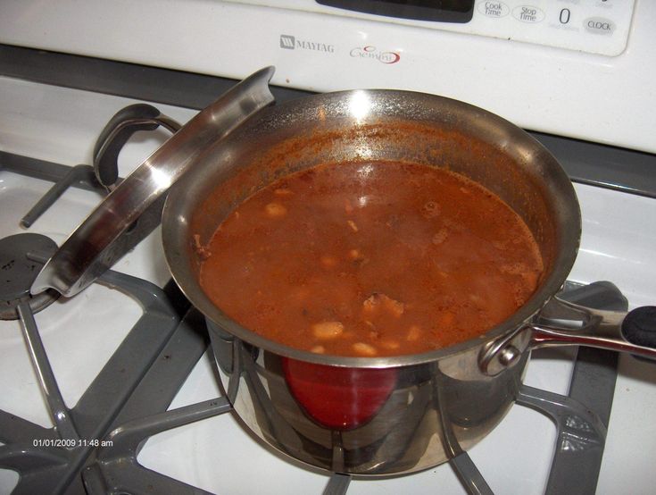 there is a pot on the stove with some food in it