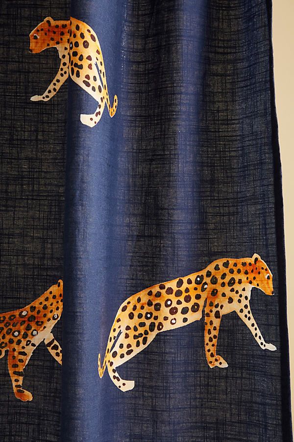 the curtain is decorated with an image of two cheetah on blue and black fabric