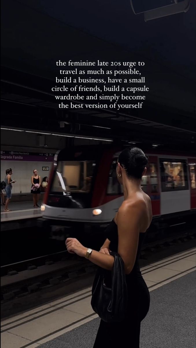 a woman is waiting for the train to arrive at the station with her hand on her hip