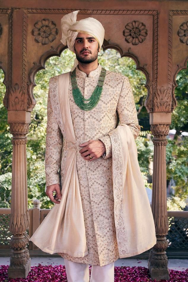 Cream sherwani with embroidered pitta work floral motifs. Comes with inner kurta and churidar.
Components: 3
Pattern: Embroidered
Type Of Work: Pitta,Zardozi
Neckline: Mandarin Collar
Sleeve Type: Full
Fabric: Matka Silk
Color: Cream
Other Details: 
Weight: 2 Kgs
Closure: Sherwani: Front closure
Note: Safaa, belt, neckpiece and dupatta worn by the model is not for sale
Occasion: Wedding,Destination Wedding,Groom - Aza Fashions Raw Silk Sherwani With Traditional Drape For Ceremonies, Traditional Drape Raw Silk Sherwani For Ceremonies, Traditional Churidar With Naqshi For Ceremonies, Traditional Anarkali Set With Naqshi For Ceremonies, Traditional Naqshi Anarkali Set For Ceremonies, Elegant Sherwani With Dupatta For Traditional Ceremonies, Traditional Drape Nehru Jacket For Ceremonies, Transitional Nehru Jacket For Traditional Ceremonies, Traditional Raw Silk Sherwani For Ceremonies